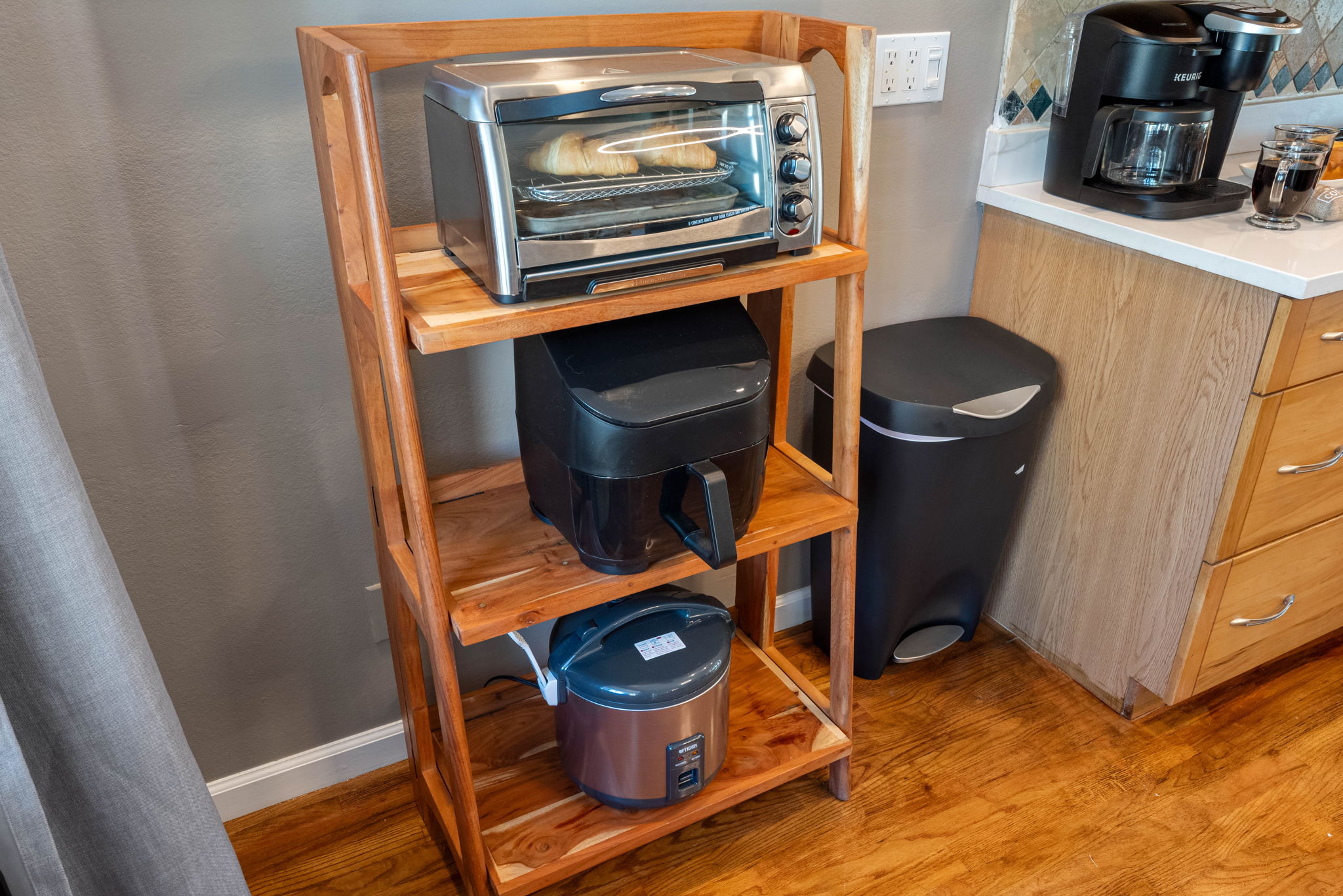 Equipped with a stainless steel oven, microwave, and French-door refrigerator, this kitchen is designed to meet every cooking need.