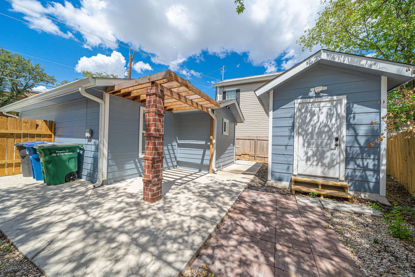 Shed to the right is an outdoor game room with a TV