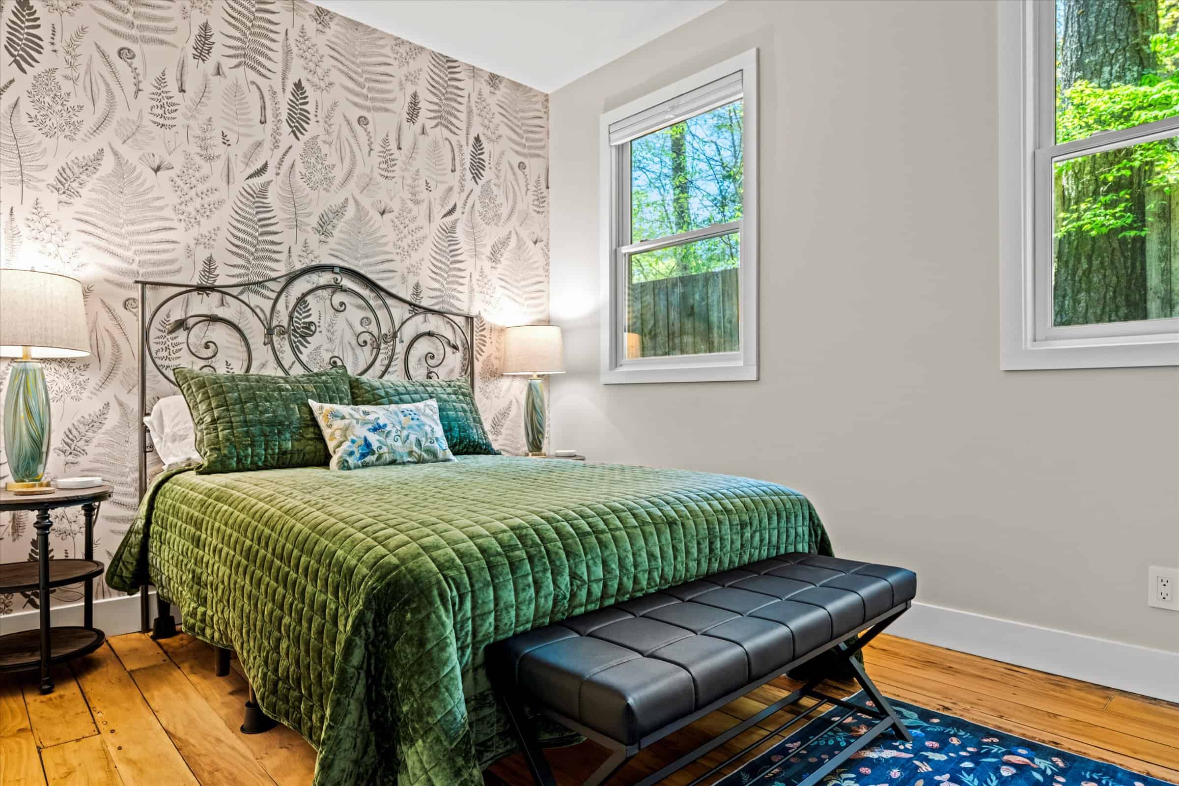 The guest bedroom with queen bed is inspired by a vintage botanical theme.