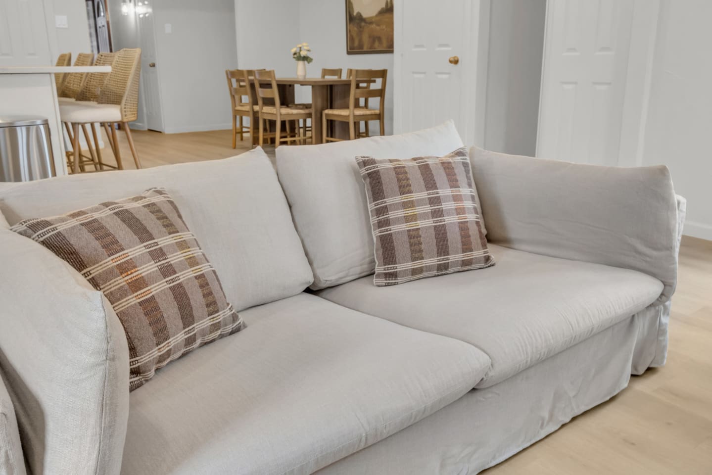 Cozy sofa in the main private living room, just steps away from the dining table and bright, airy kitchen.
