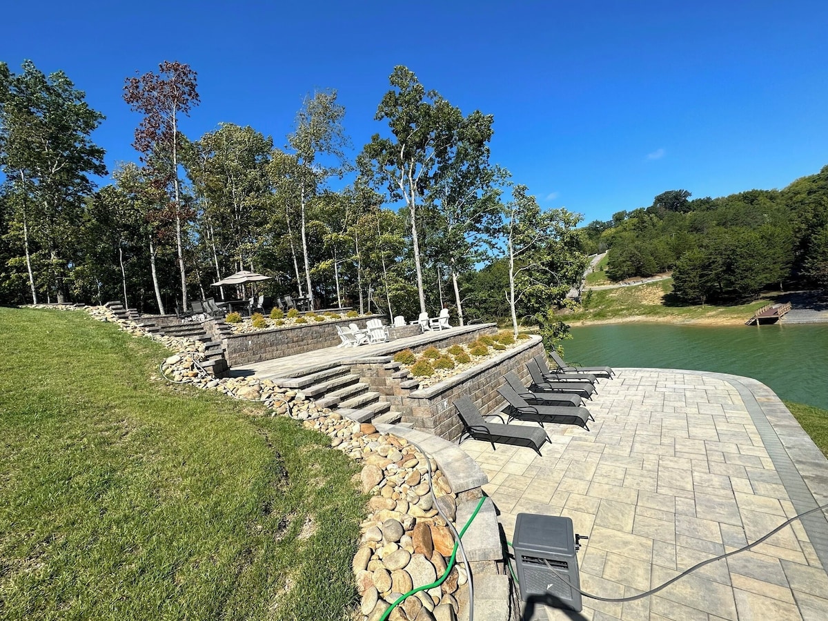 Bottom Patio with lots of lounge chairs and water on 2 sides