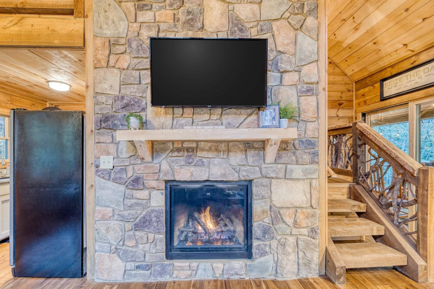 The fireplace cozies up beneath the flat screen TV, offering the perfect blend of comfort and technology for evenings filled with relaxation and entertainment.