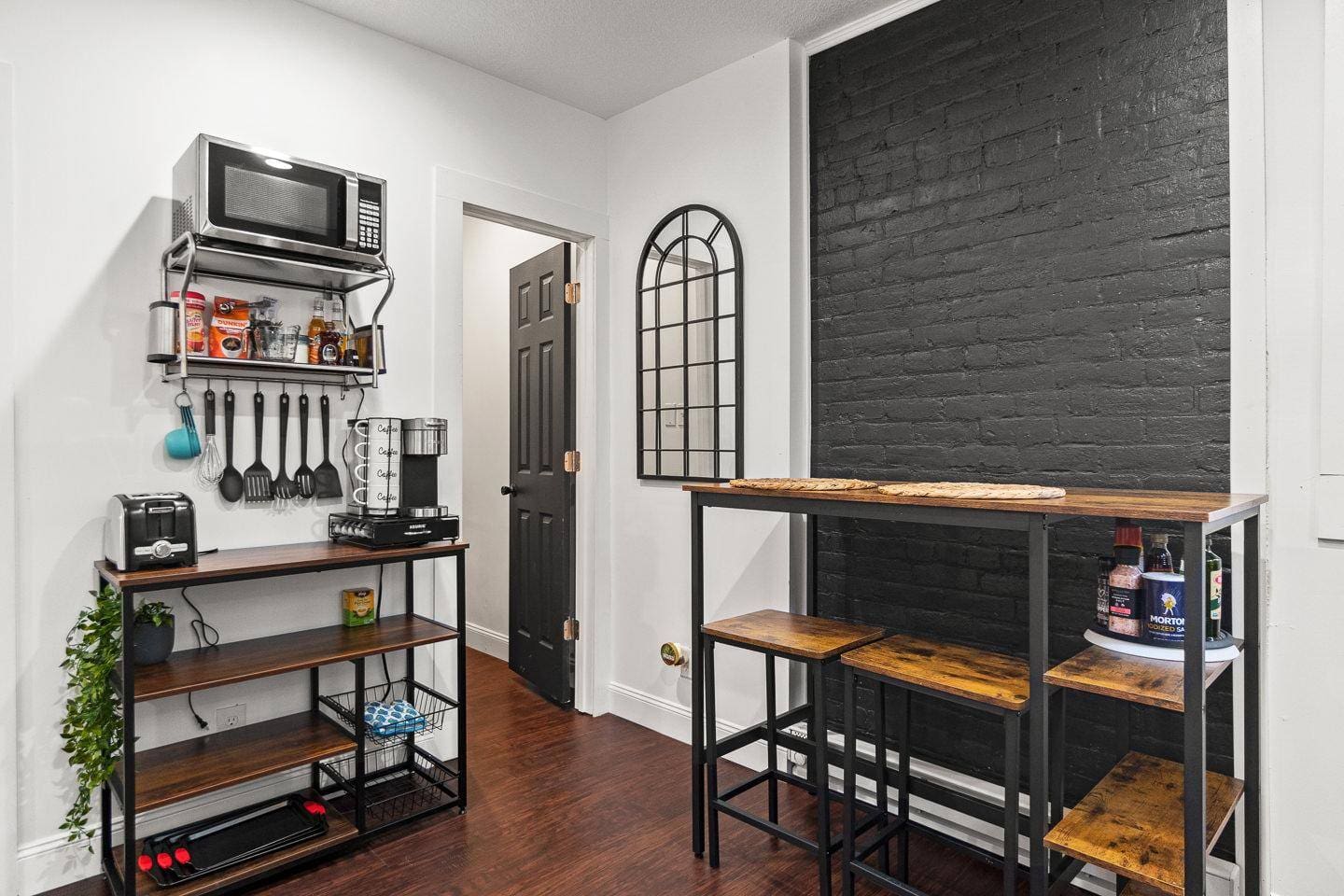 Bright and welcoming dining nook featuring stylish bench seating and a unique mirror accent. A cozy spot to enjoy meals or relax with a cup of coffee!