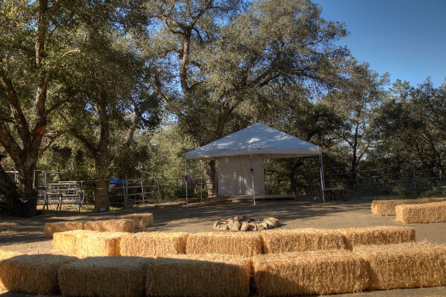 Corral area with haystacks, campfire and small stage