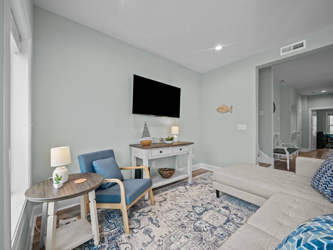 Living room with sectional, chair, and 55" TV