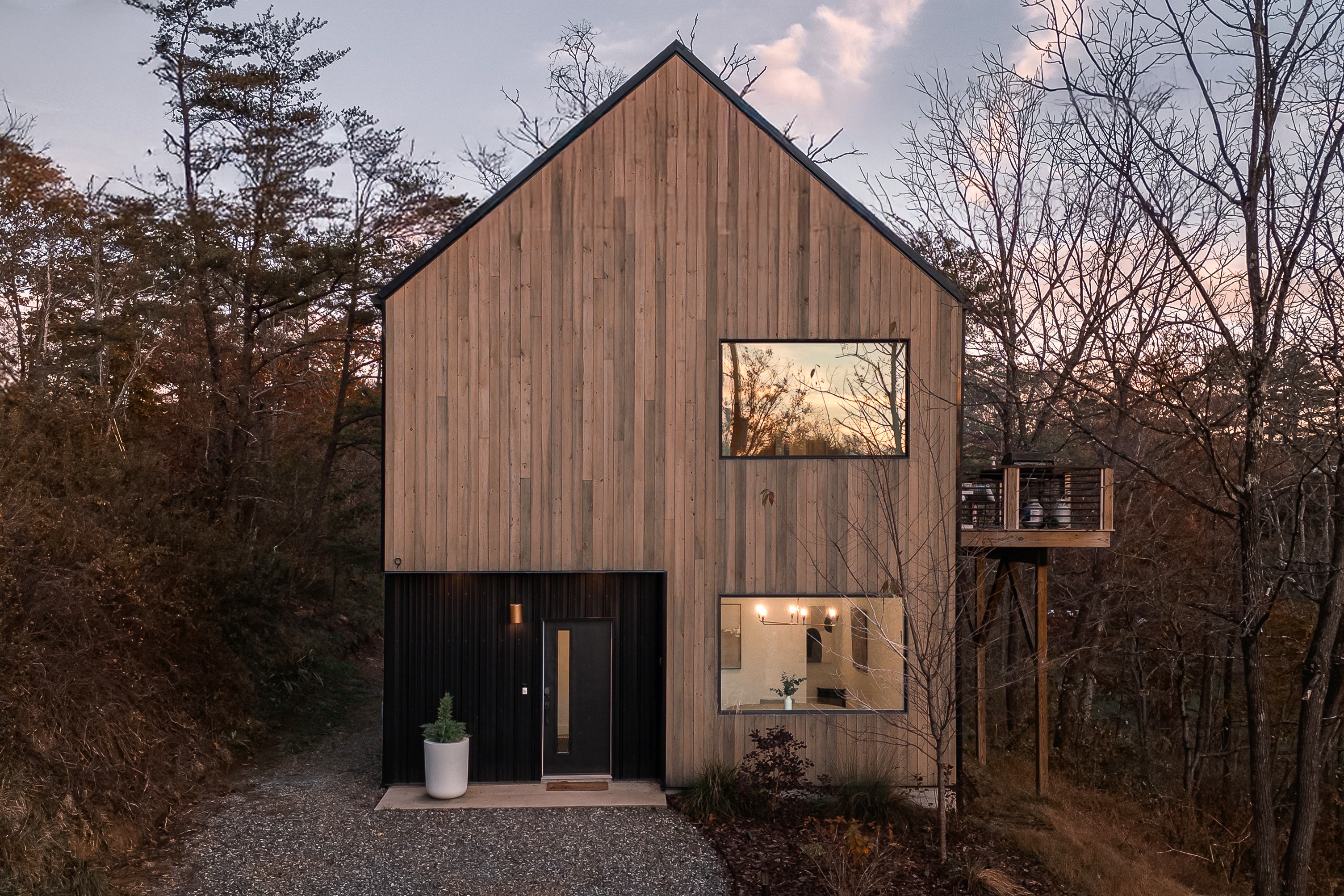{Exterior} A modern silhouette wrapped in warm wood and sunset reflections—your elevated hideaway in the Blue Ridge.