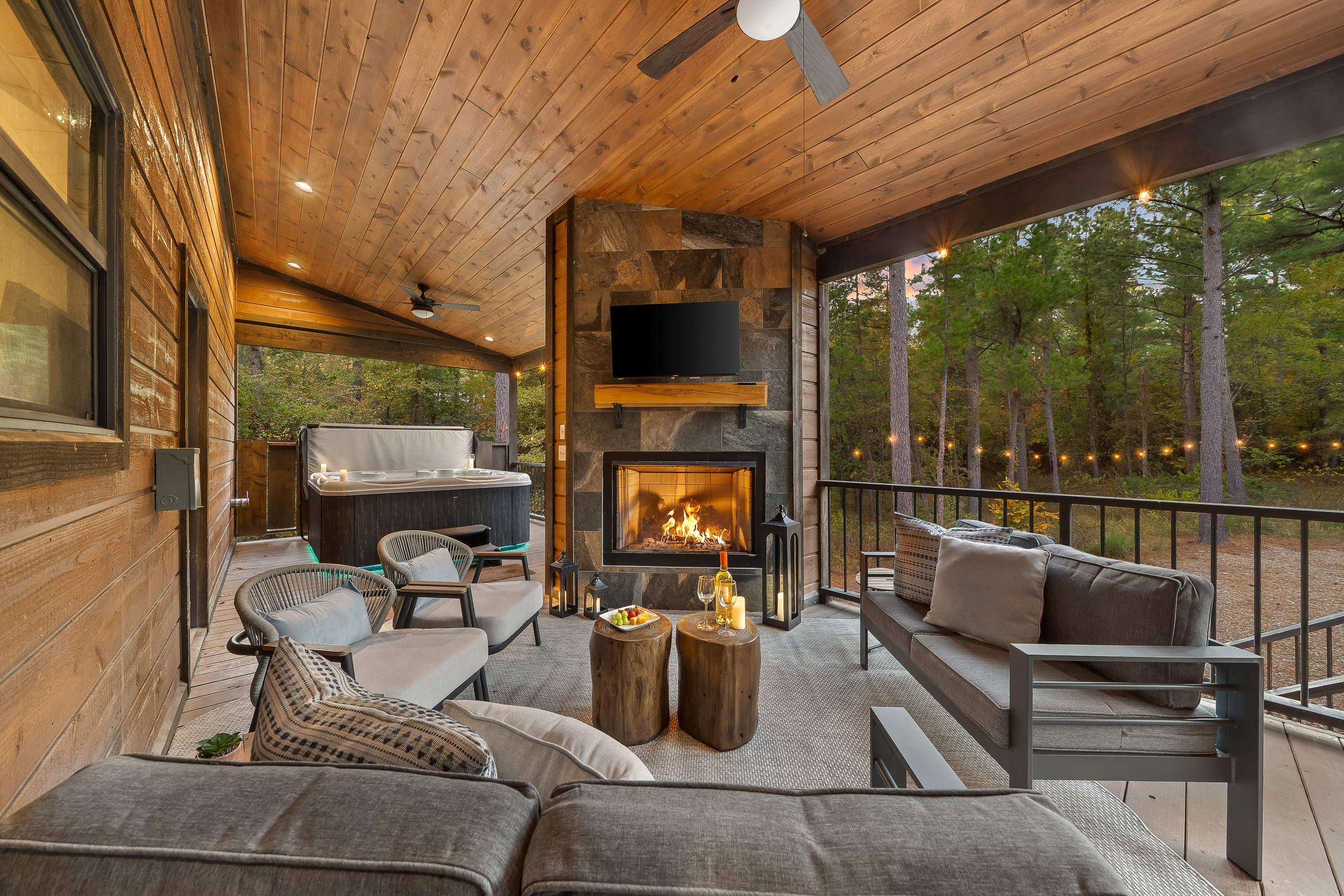 Outdoor living at its finest. Cozy seating, a glowing fireplace, and a hot tub only steps away set the scene for unforgettable nights.