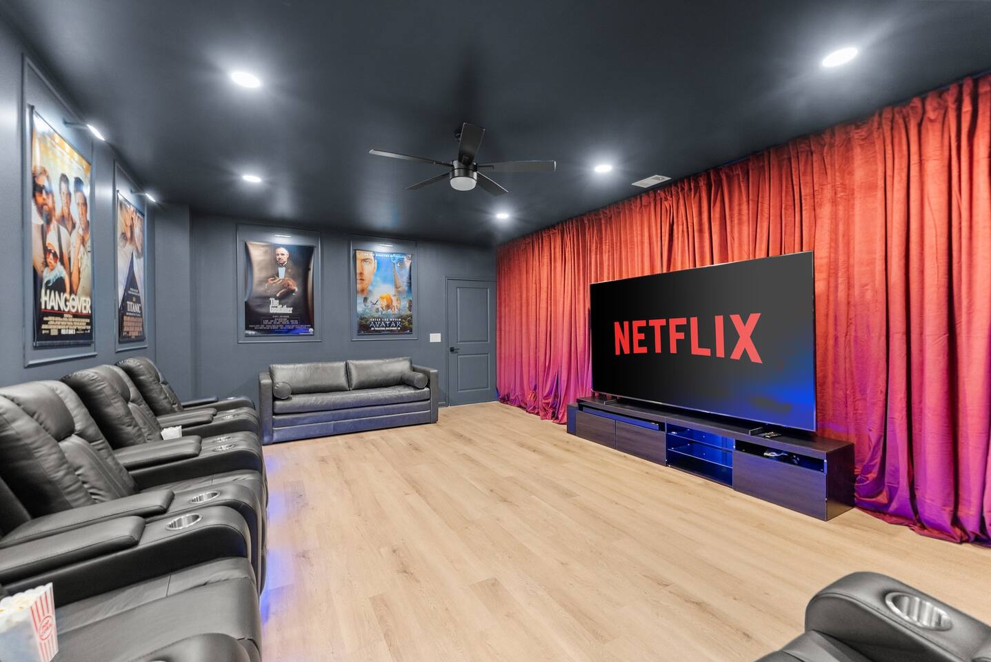 Theater room with a large screen and soundbar