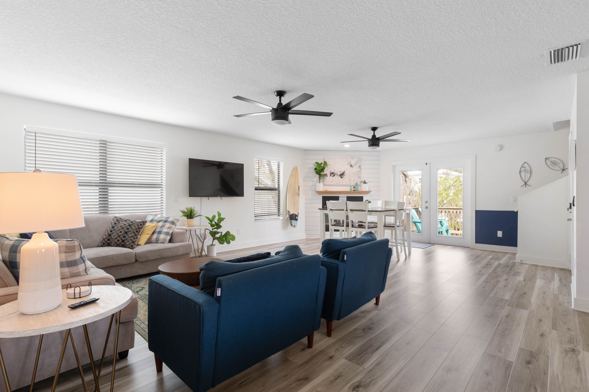 From slow coffee at the table to movie nights on the couch, this bright gathering space keeps everyone together. Sunlight pours in, the deck waits just outside, and every easy conversation feels like another piece of the family trip you will remember.