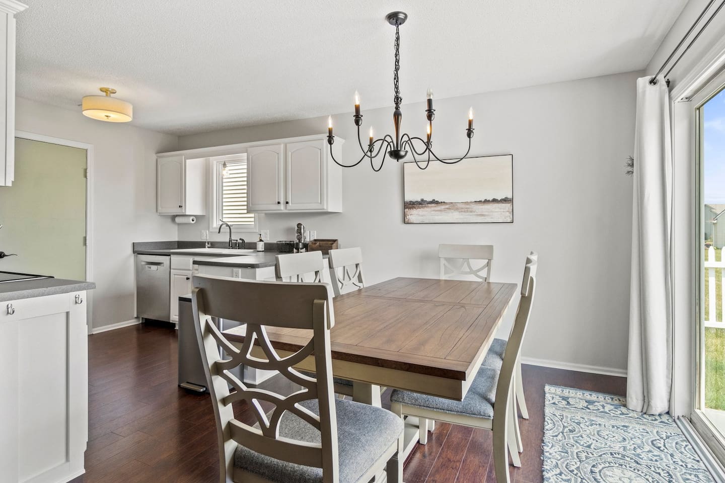 The dining space flows beautifully into the fully equipped kitchen, perfect for easy serving and post-meal cleanup.