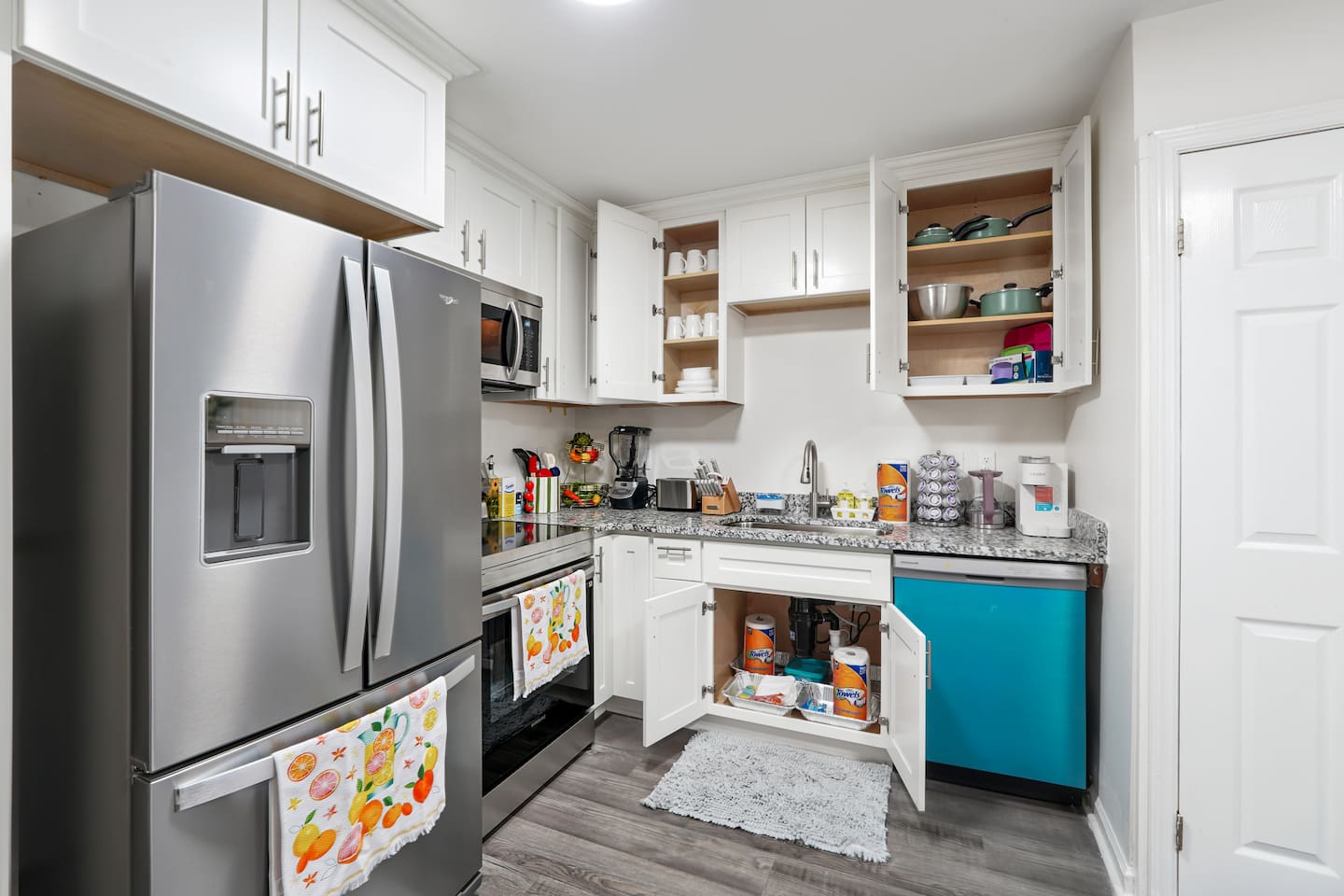 Full kitchen thoughtfully stocked with everything you may need including cookware, utensils, dishes, and essential appliances perfect for preparing meals and enjoying a true home-away-from-home experience.