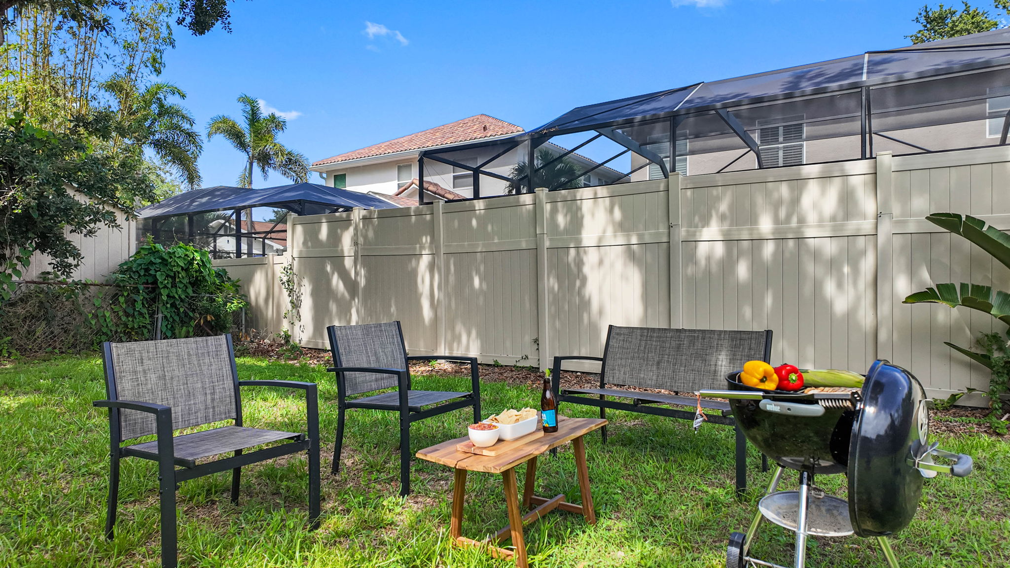 Surrounded by a clean and modern horizontal wood plank fence, this backyard offers peace of mind and a sense of seclusion.