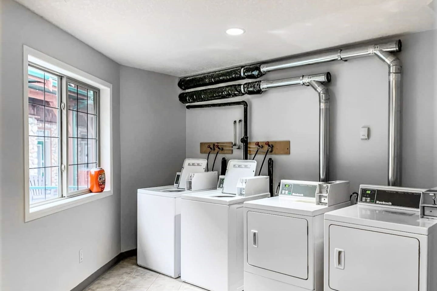 Shared laundry area in the pool house. Several washers and dryers.  It uses a Coinomatic phone app to operate. 