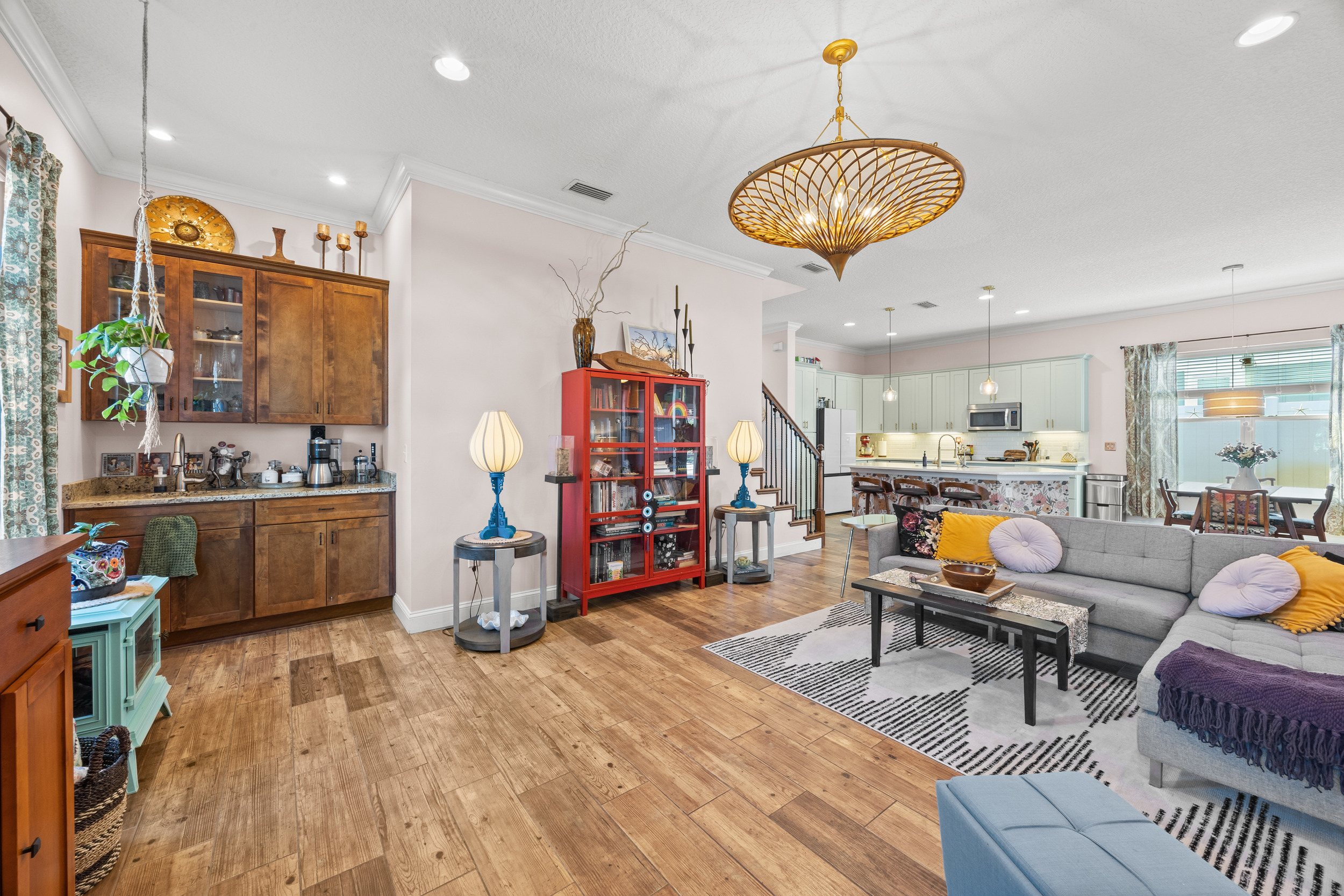 Spacious open‑concept living area with modern kitchen and dining space in Jacksonville Beach vacation home.