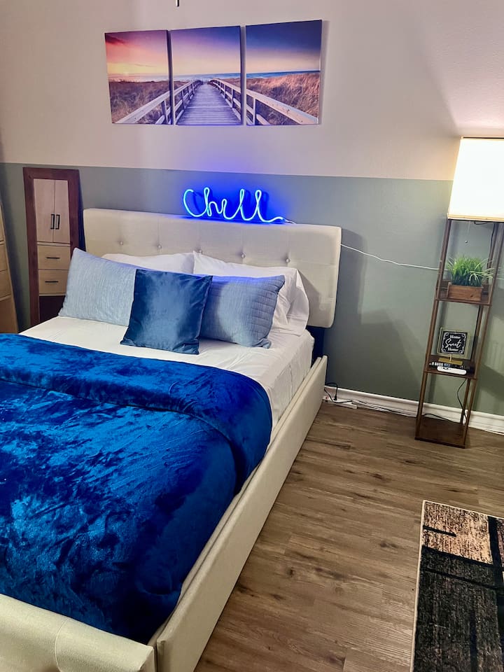 Queen bed with floor space nearby and an easy layout for moving around the studio.
