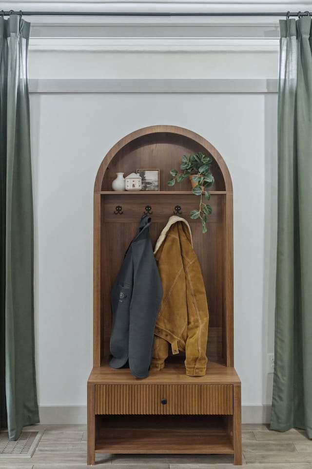 Charming entry nook with a built-in bench and coat hooks, giving guests a convenient spot to store jackets, bags, and shoes.