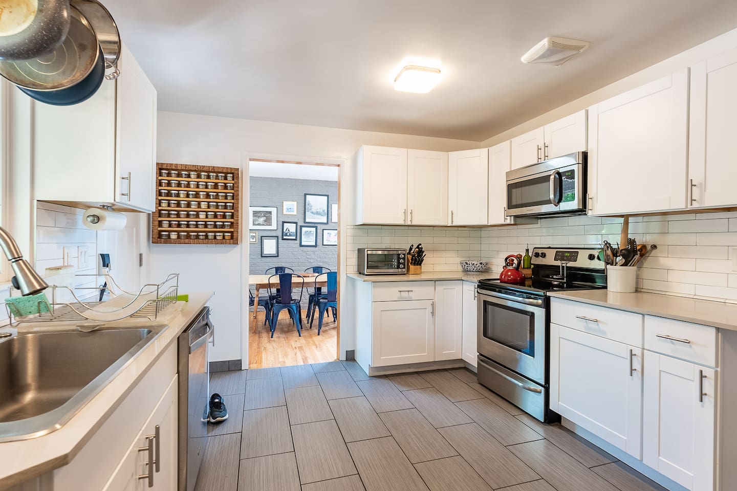 Well-appointed kitchen with plenty of servingware, cooking and baking tools, cutlery, and utensils