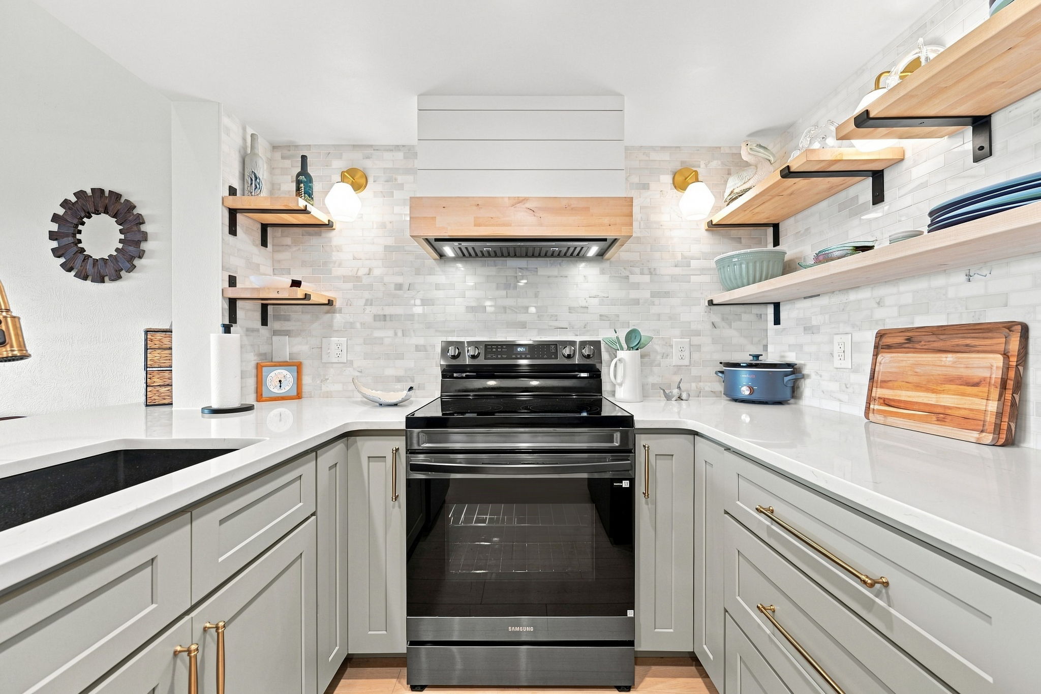 Sleek updated fixtures, crisp white countertops, and a crockpot ready for those effortless vacation dinners.
