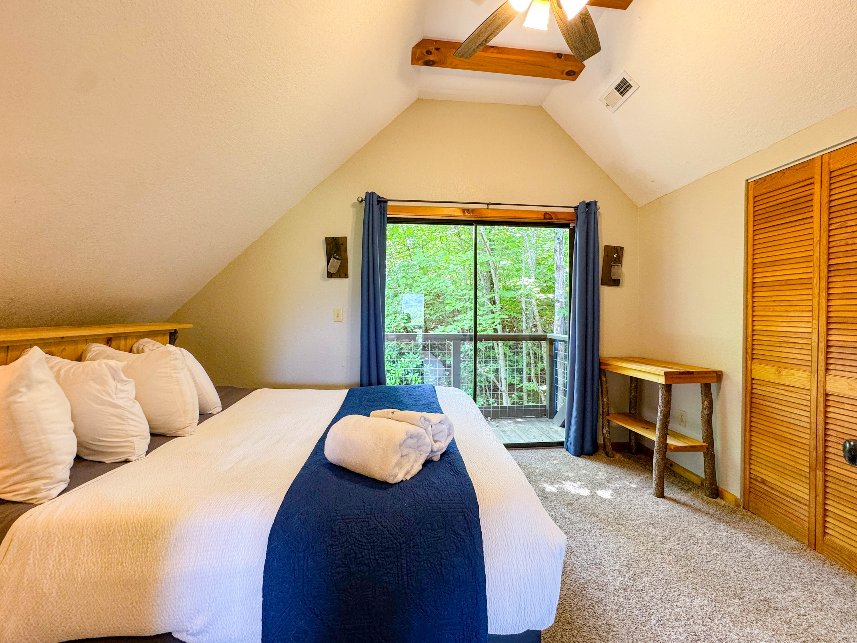 the back upper level bedroom features a hybrid memory foam bed and shredded bamboo pillows. There is a private Juliet balcony as well. This room also has a crib in the closet:)