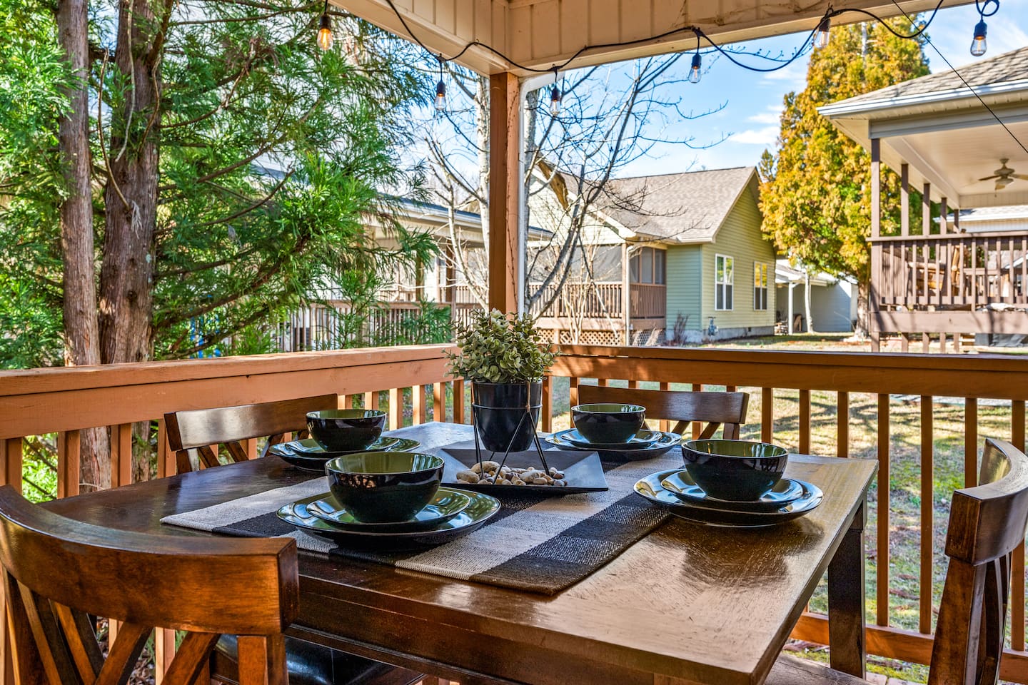 Enjoy meals al fresco on the covered deck, complete with a cozy dining set for four and a peaceful view of the neighborhood.
