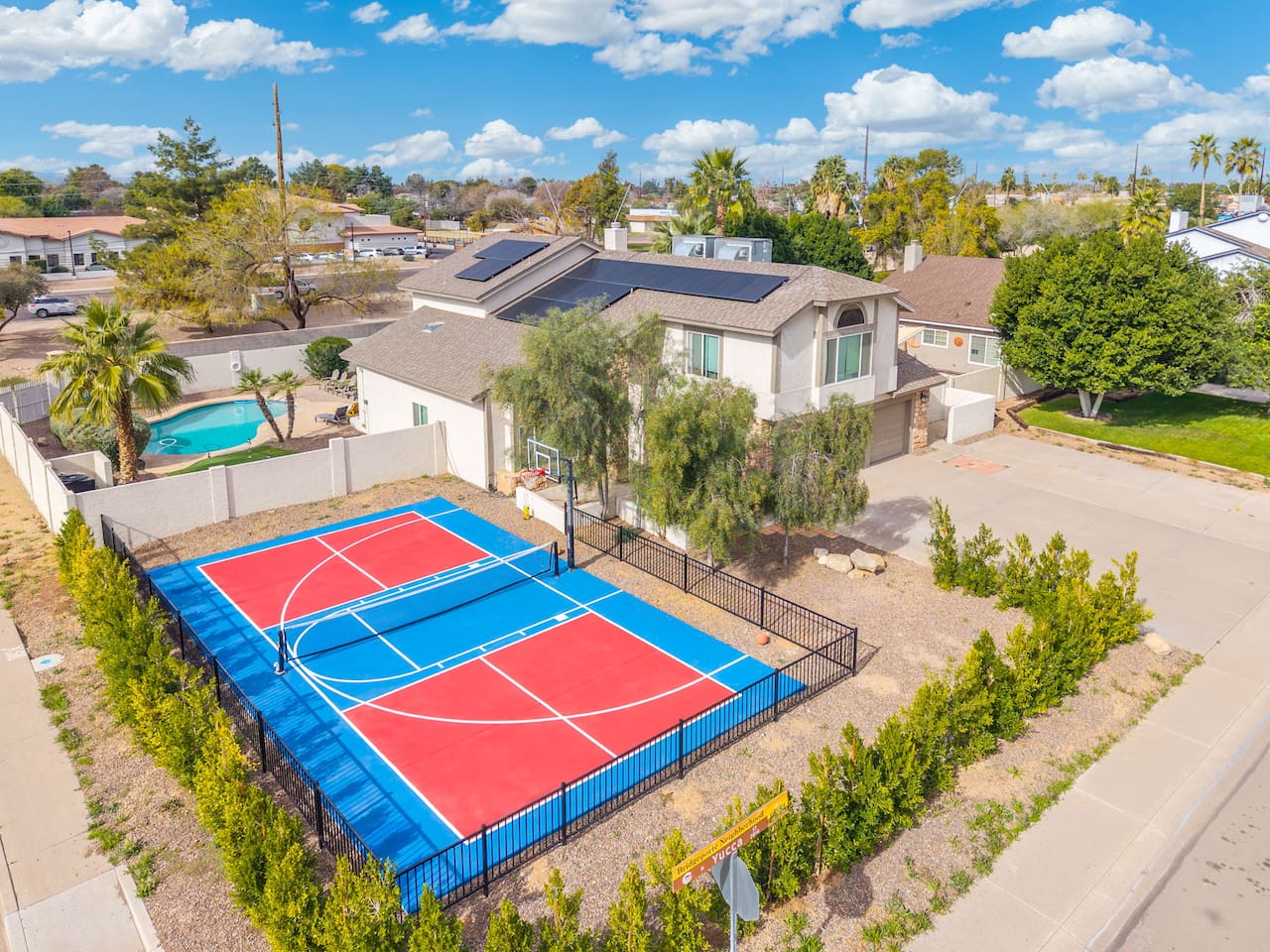 Multi-sport courts with pool access—pickleball, basketball, and tennis all in one property.