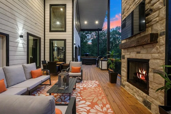 Covered outdoor lounge with fireplace