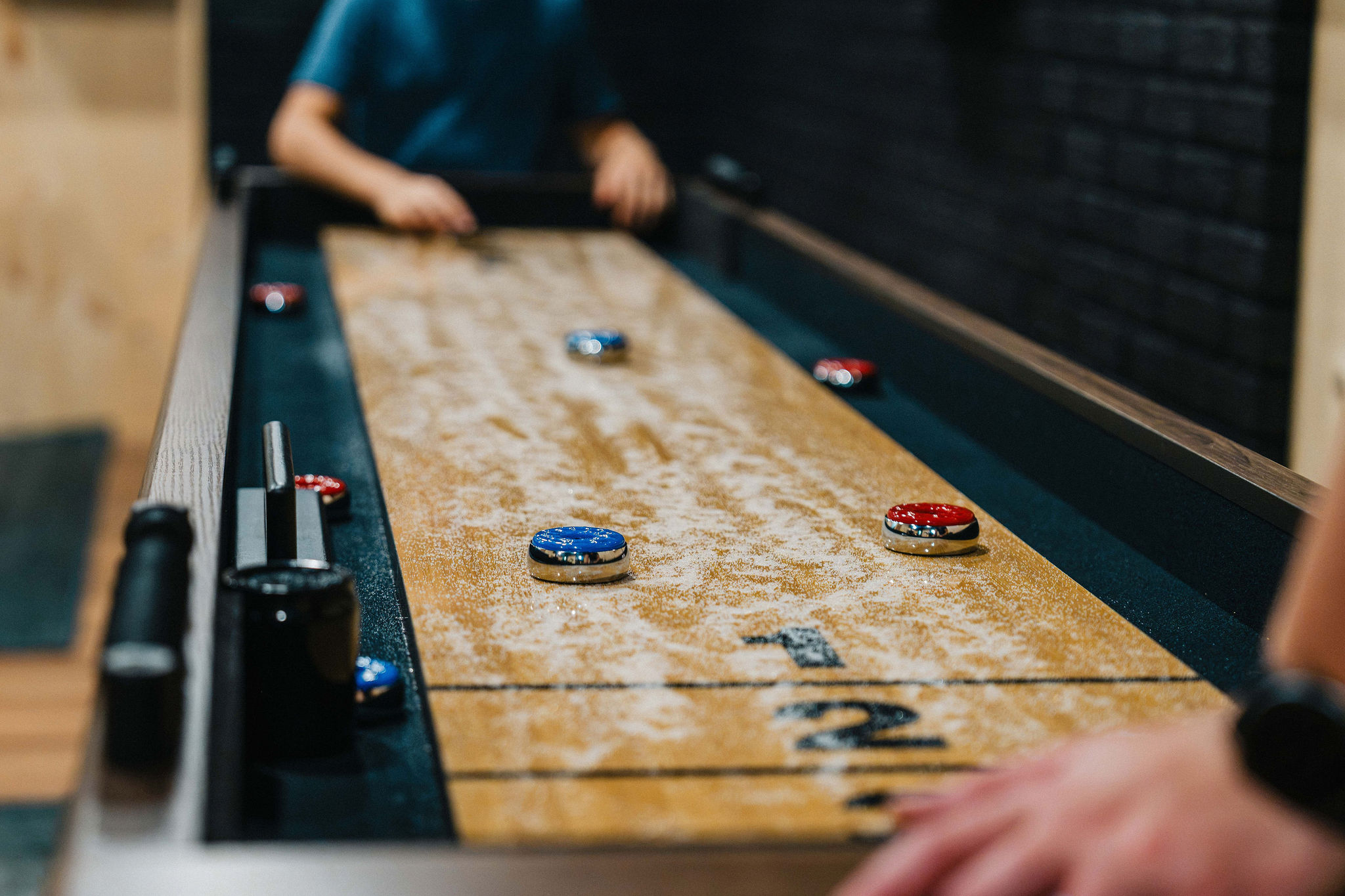 🛷 Full-size shuffleboard table — one of the most-played things in the house.