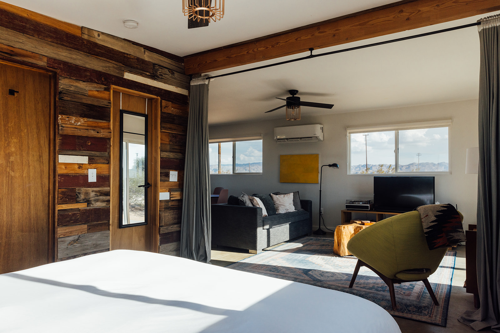 Open flow design with seamless transition from bedroom to living room, creating a warm and welcoming retreat