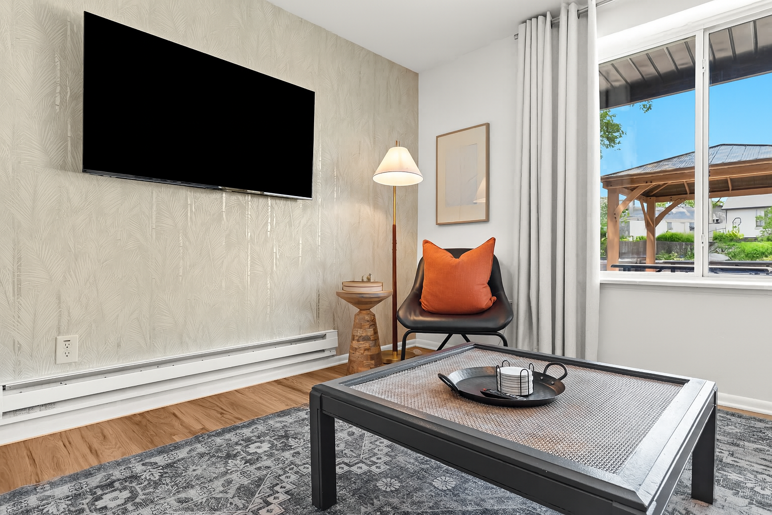 Cozy reading corner beside a mounted Smart TV—great for winding down after a day out.