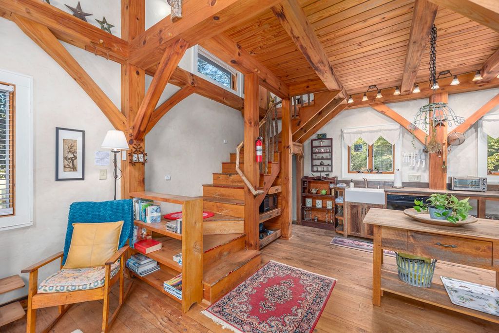 The steps to the sleeping loft are located to the left of the kitchen and living room. 