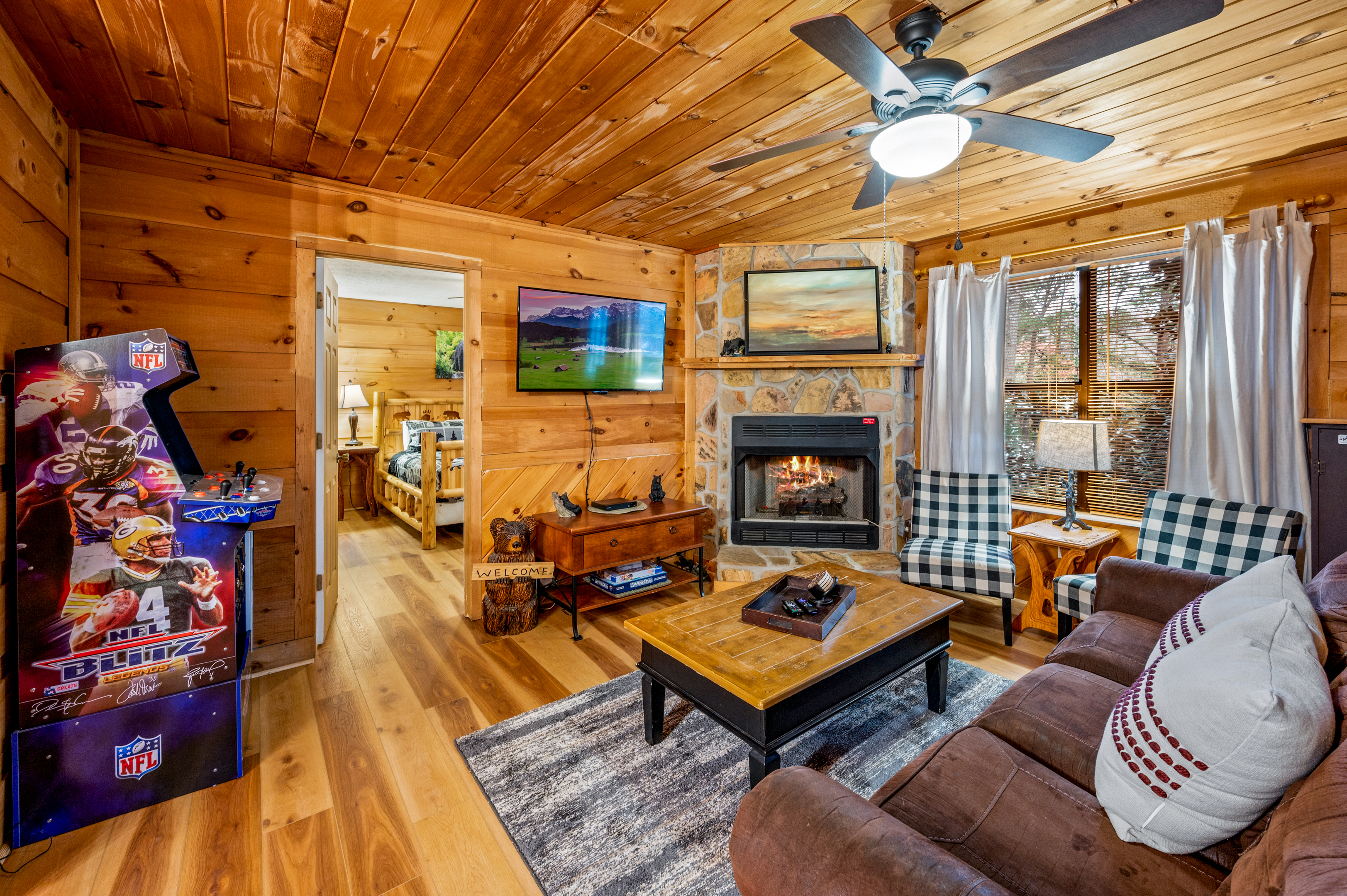 Living Room area with plenty of seating , gas fireplace, arcade, and Free Little Library for use during your stay. 