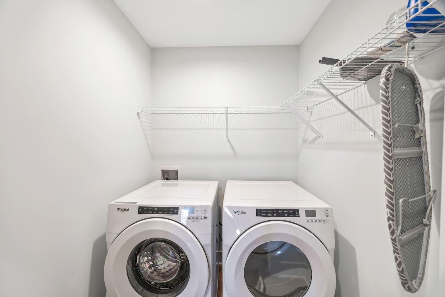 Equipped with a Whirlpool washer and dryer, plus shelving and an ironing board — everything you need to keep things fresh during your stay.