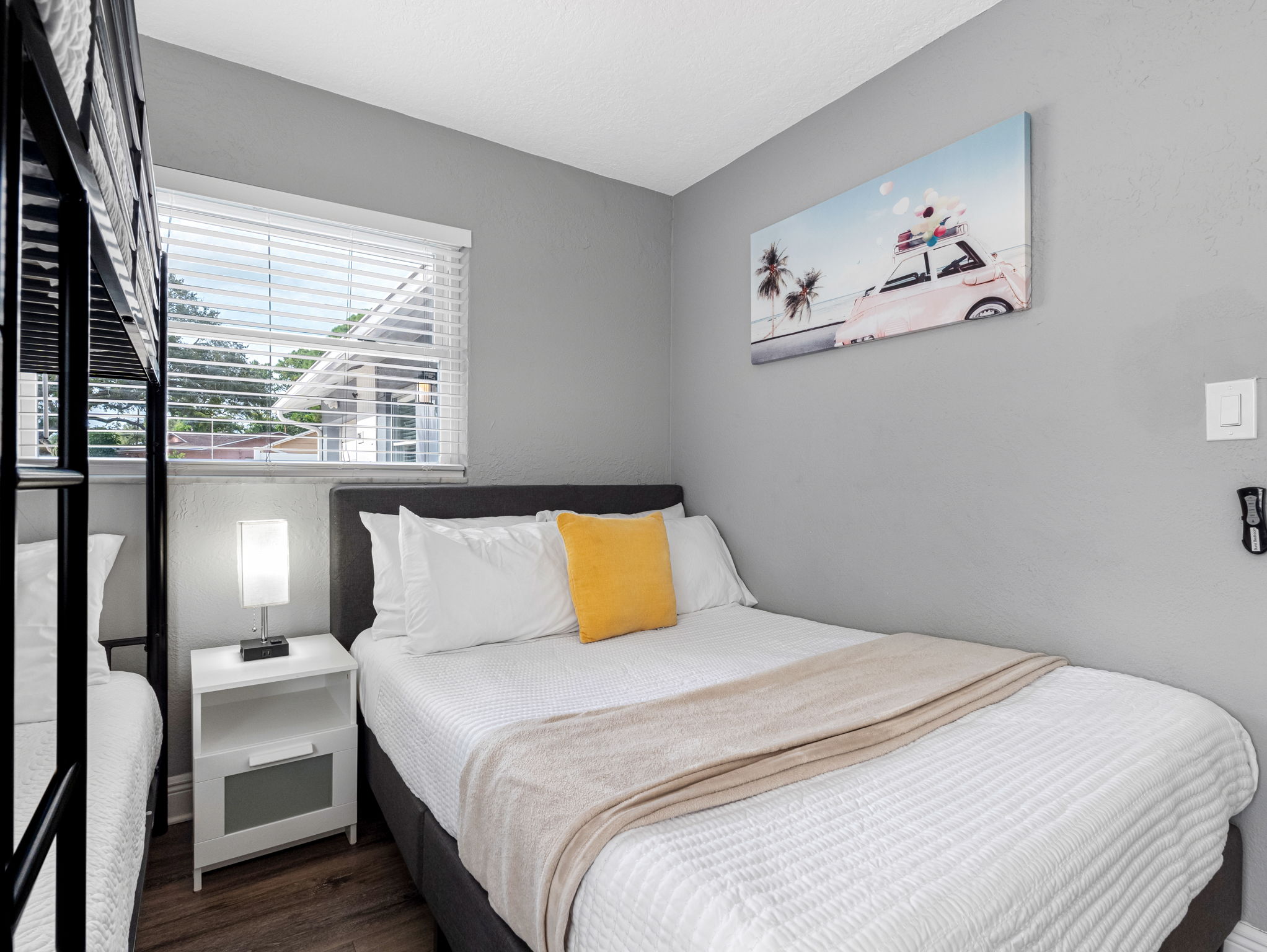 Designed with space efficiency in mind, this room offers a full bed for adults and a cool bunk setup for the kids—all in one tidy layout.