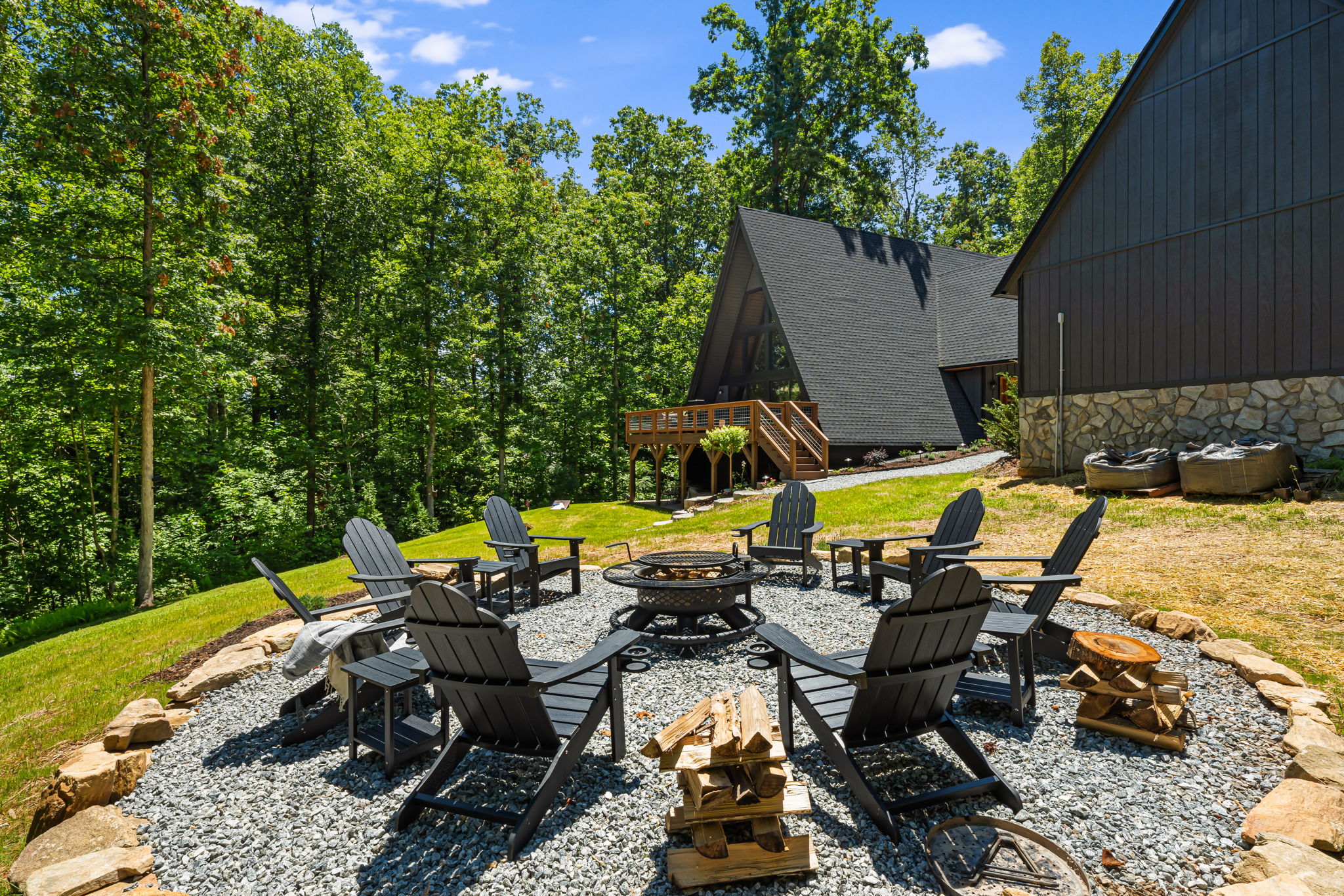 Gather with friends & family at the firepit, with 8 classic Adirondack chairs + side tables on a gravel pad and a boulder border. Whether you're roasting marshmallows, sharing stories, or stargazing, this cozy outdoor setup is made for unforgetable moments