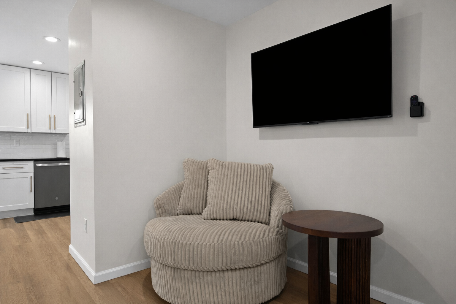 Cozy reading and relaxation nook with a plush accent chair, smart TV, and side table—perfect for unwinding, streaming, or enjoying quiet moments.