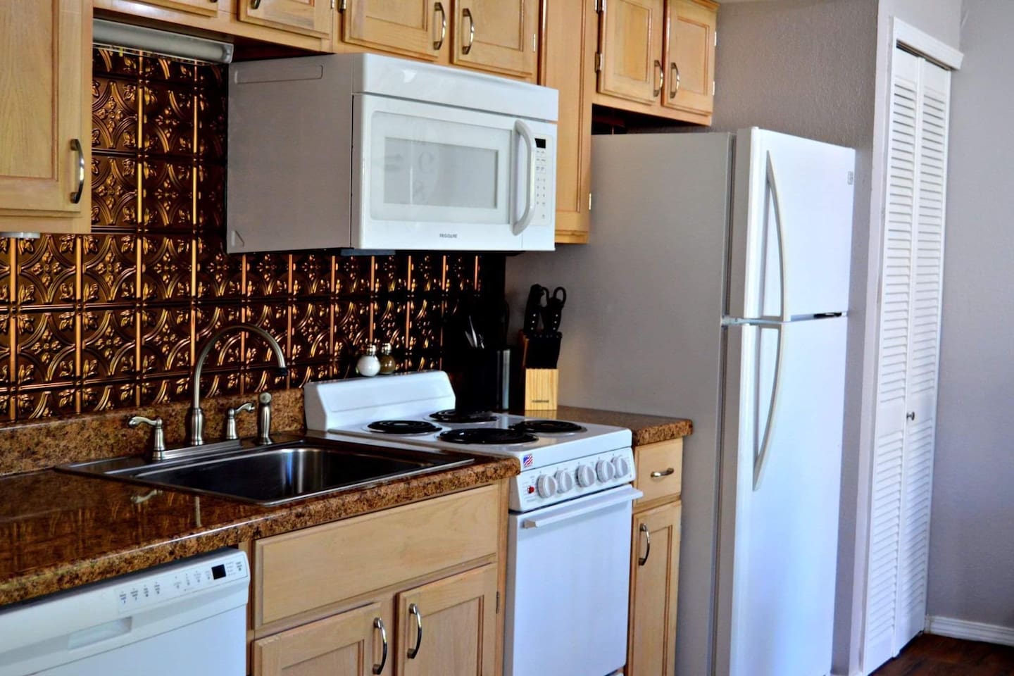 Full kitchen with stove, oven, dishwasher, microwave, and refrigerator.