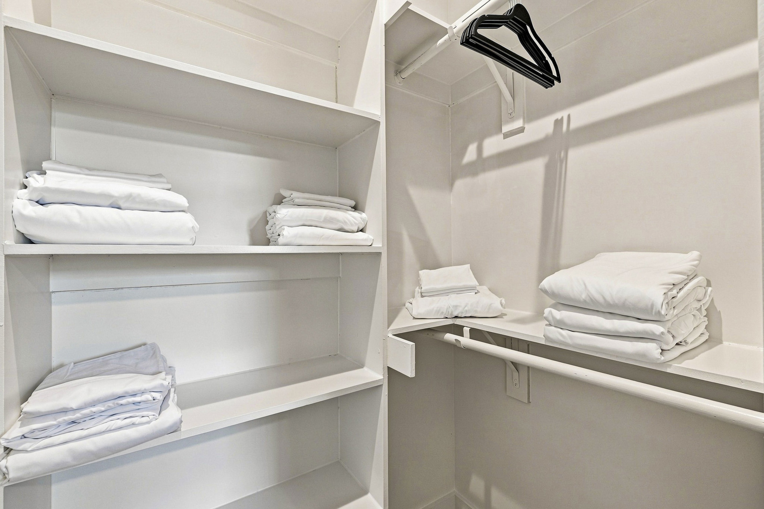 Ample shelves and fresh linens await your stay in this organized retreat!