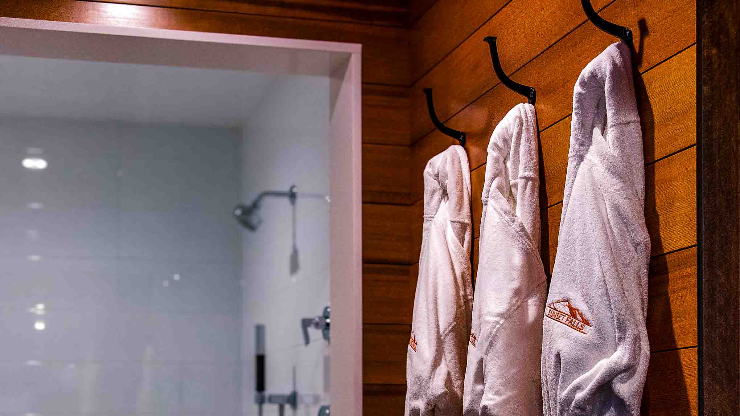 Cedar-lined dressing area with Turkish cotton robes at the entrance to the eucalyptus steam room &mdash; Sunset Falls Berkshires