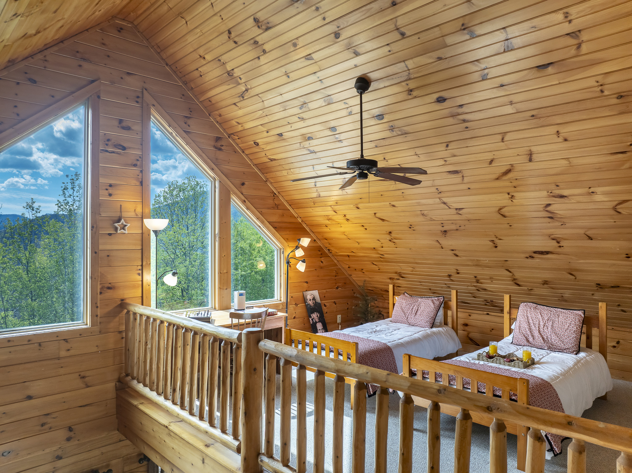 Loft Bedroom: Bright angles and natural wood create a serene escape with stunning mountain views!

