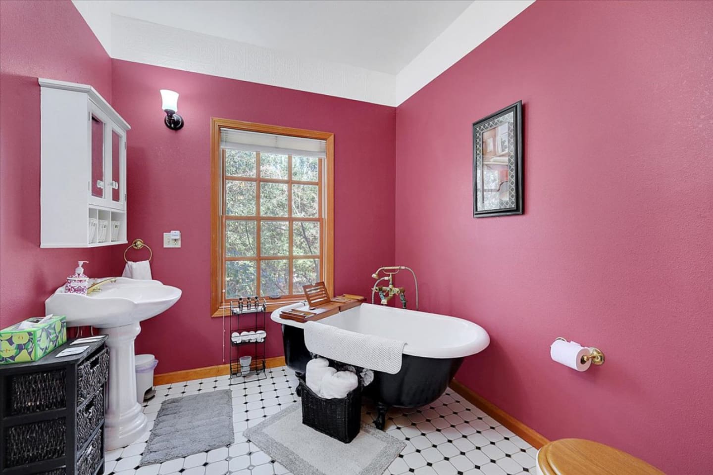 Full bathroom 2 with a clawfoot tub, pedestal sink, and a classic vintage-style look.
