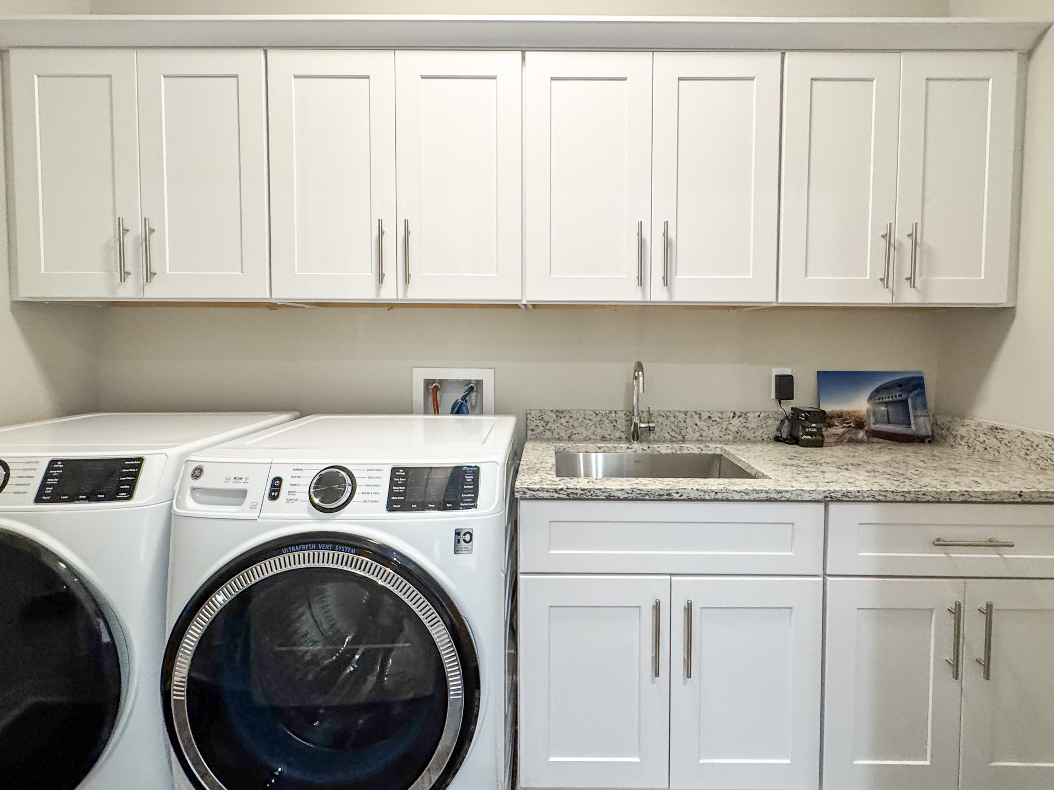 Laundry room with new appliances.