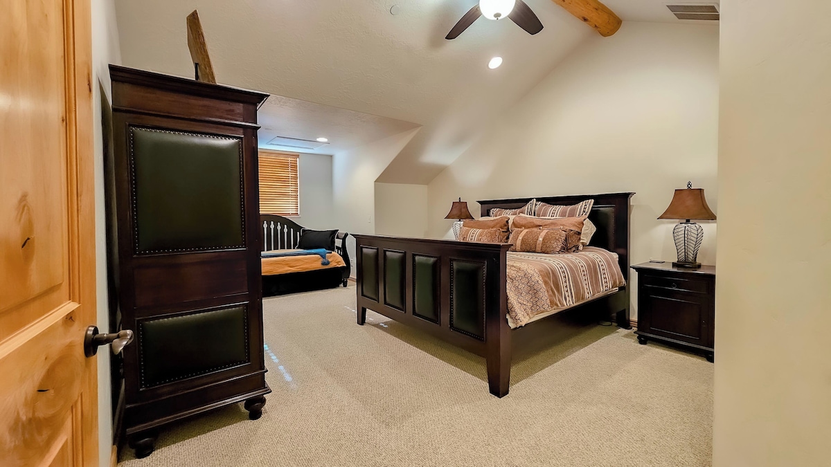 The primary bedroom is outfitted with a king bed, luxurious linens, and plush pillows. There is also a trundle bed for additional guests.