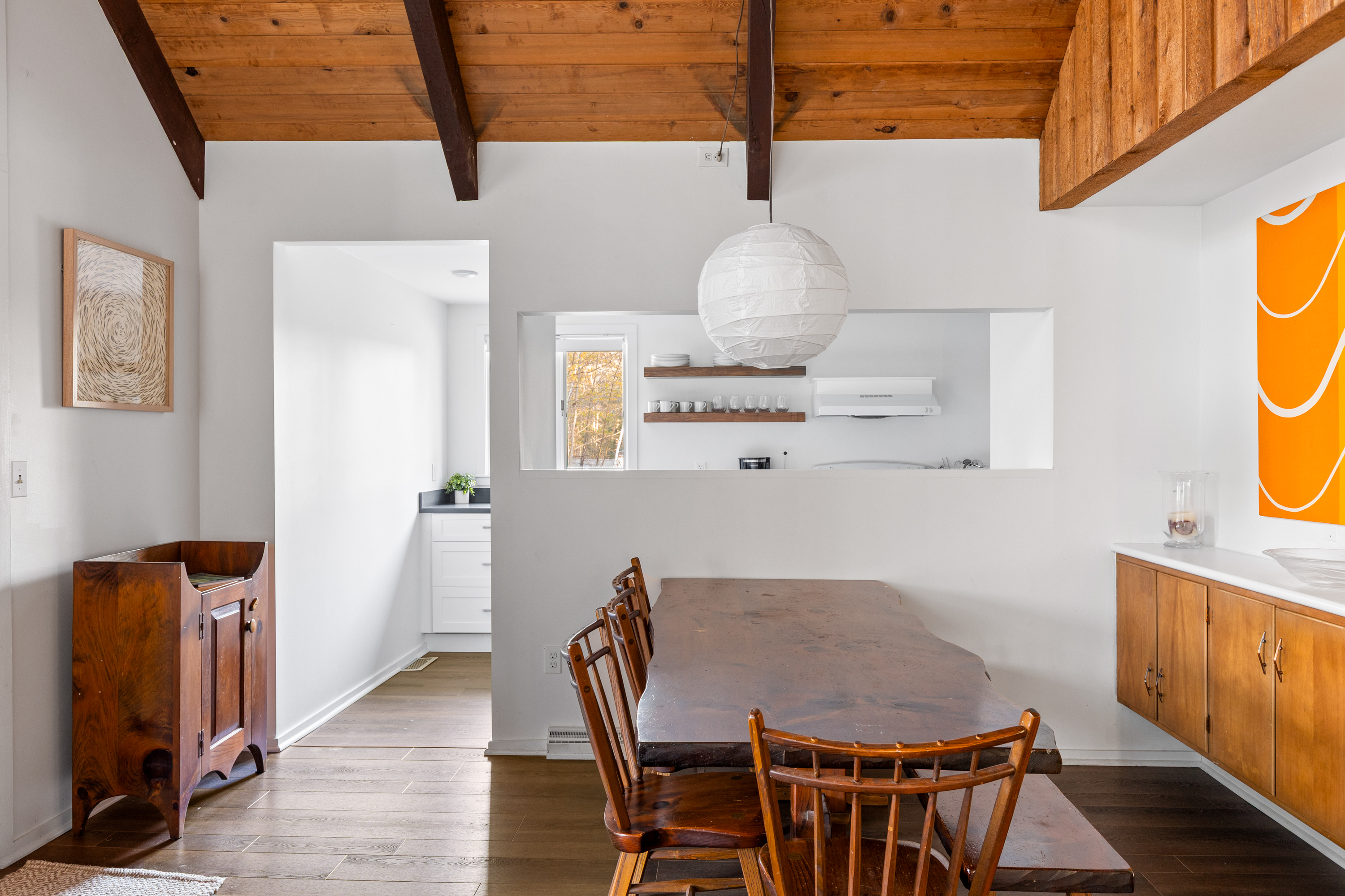 Dining Room: Enjoy meals under natural light with stunning wood beams and a charming antique table!