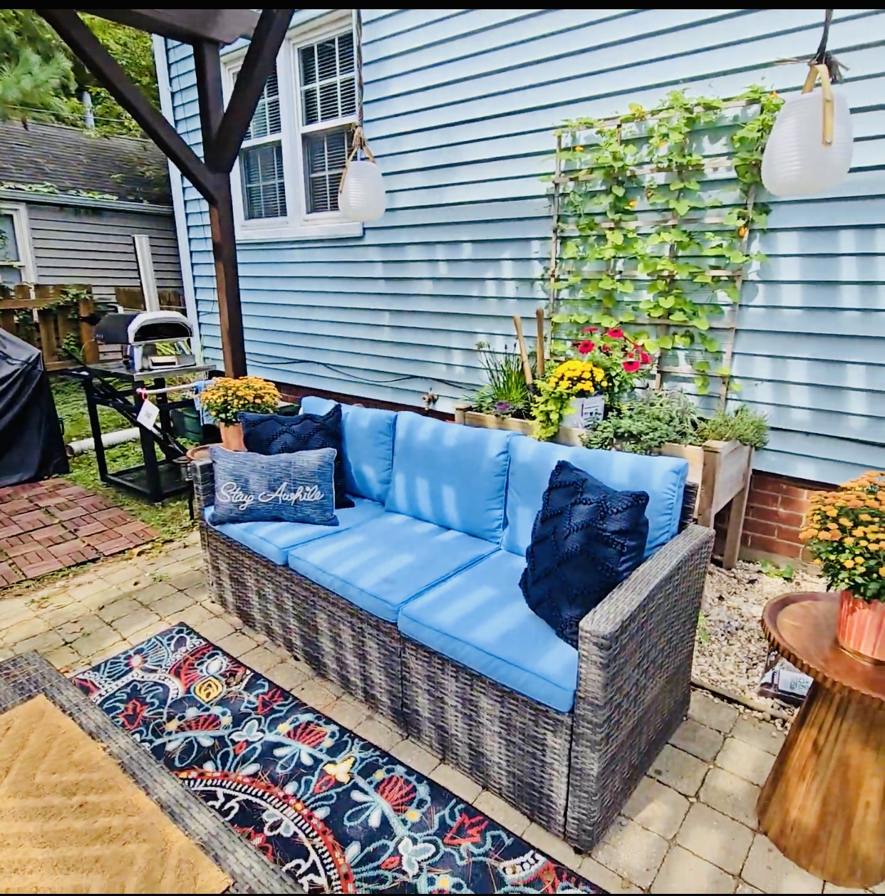 Lounge in shaded comfort beneath the pergola—our cushioned backyard sofa, dressed with inviting pillows, is just steps from the herb garden and pizza oven. It’s a cozy corner made for slow sips, shared stories, and savory moments.