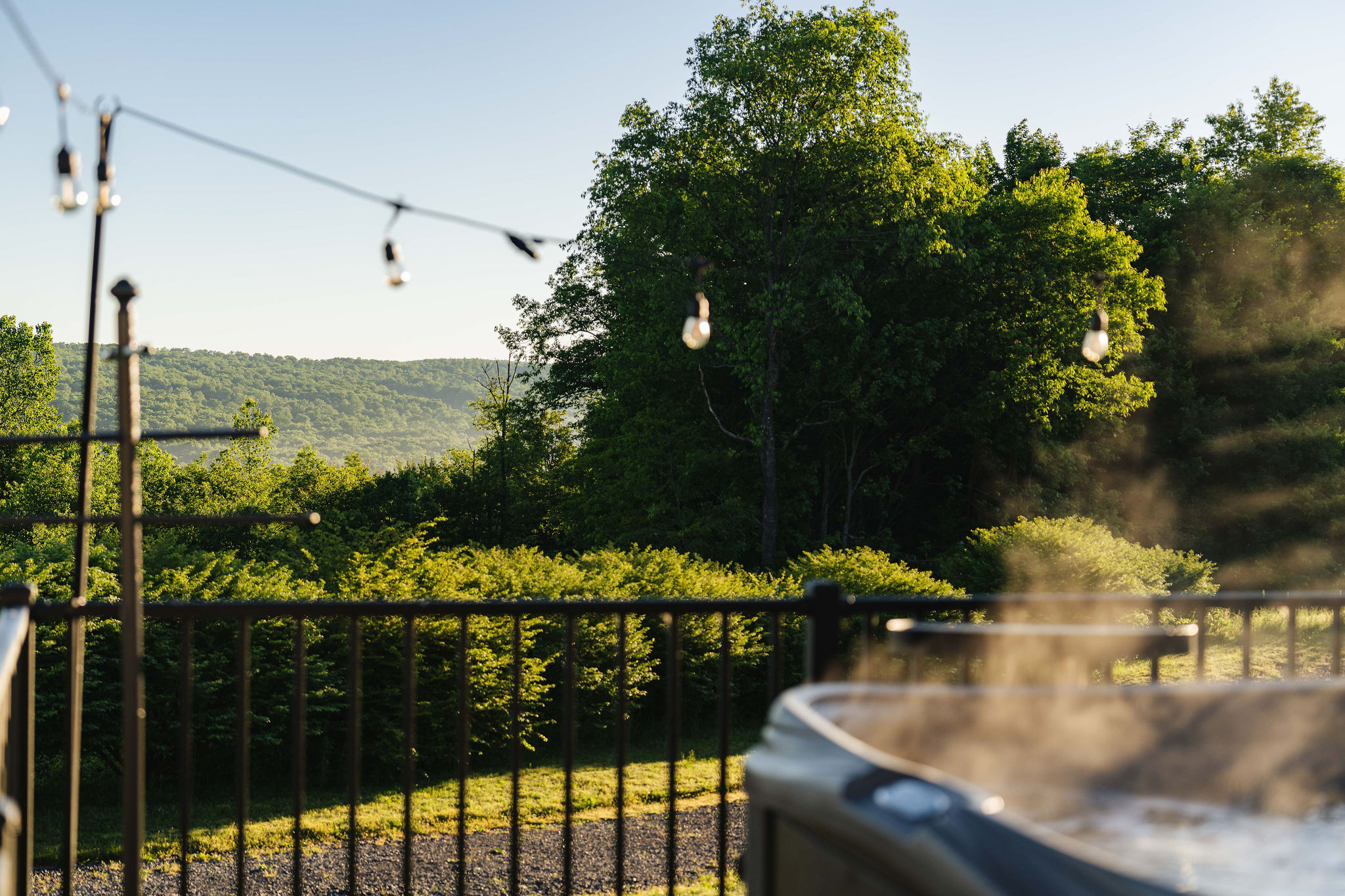 🛁 Hot tub with wood-slat privacy walls — soak in peace.