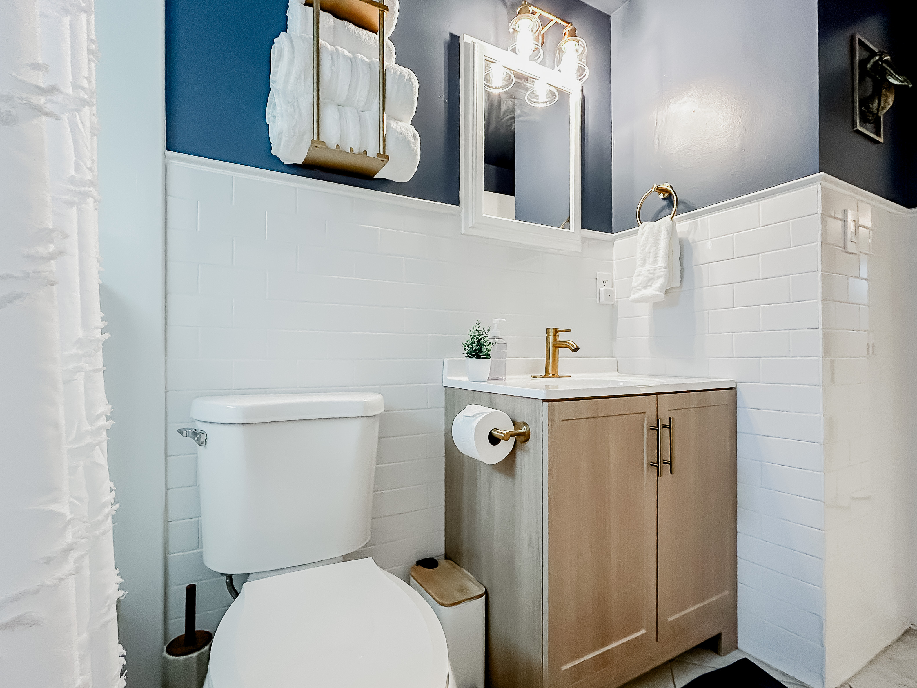 Full Bathroom with Shower, Toilet, Vanity, Towels, Mirror, & More