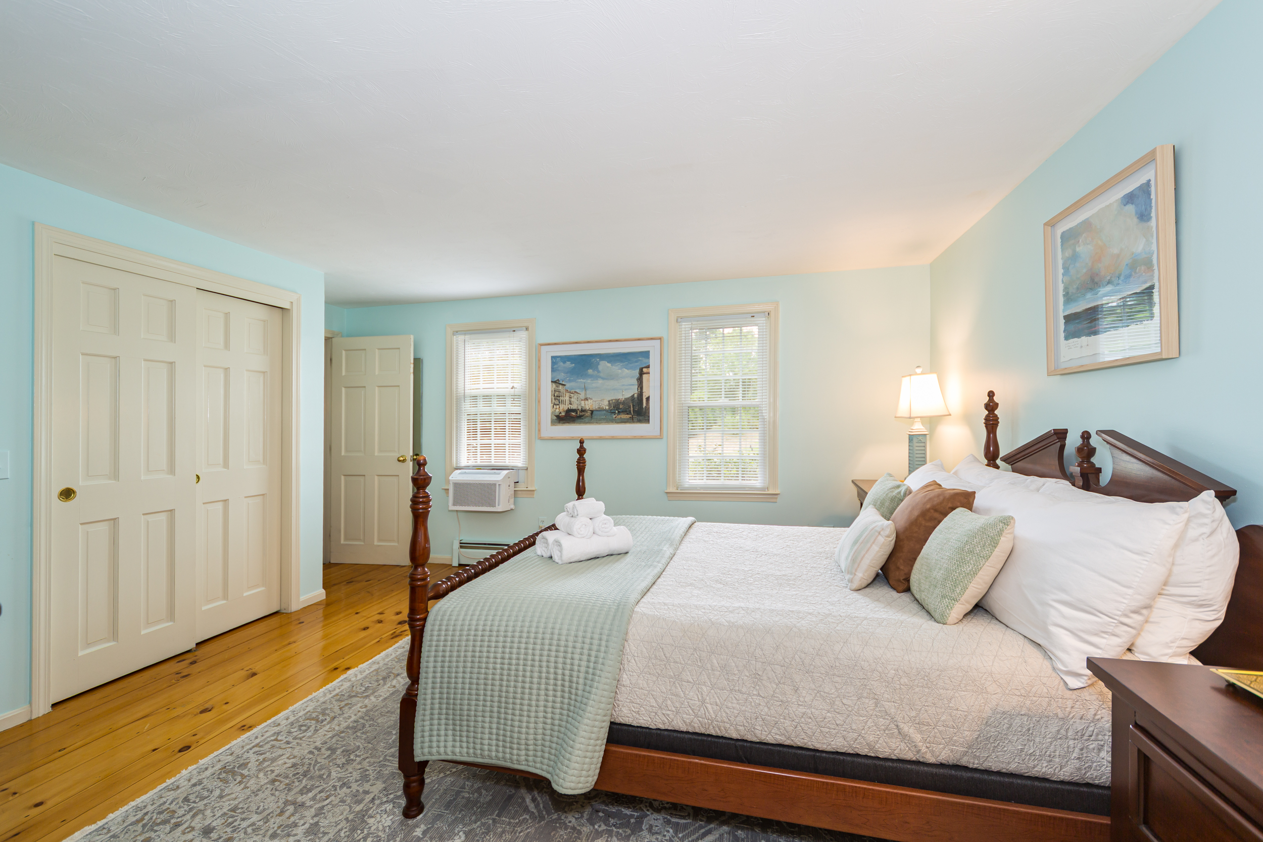 Main floor bedroom with queen bed and shared ensuite