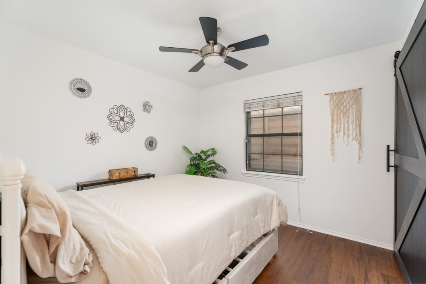 Guest bedroom with queen bed and minimalist design.