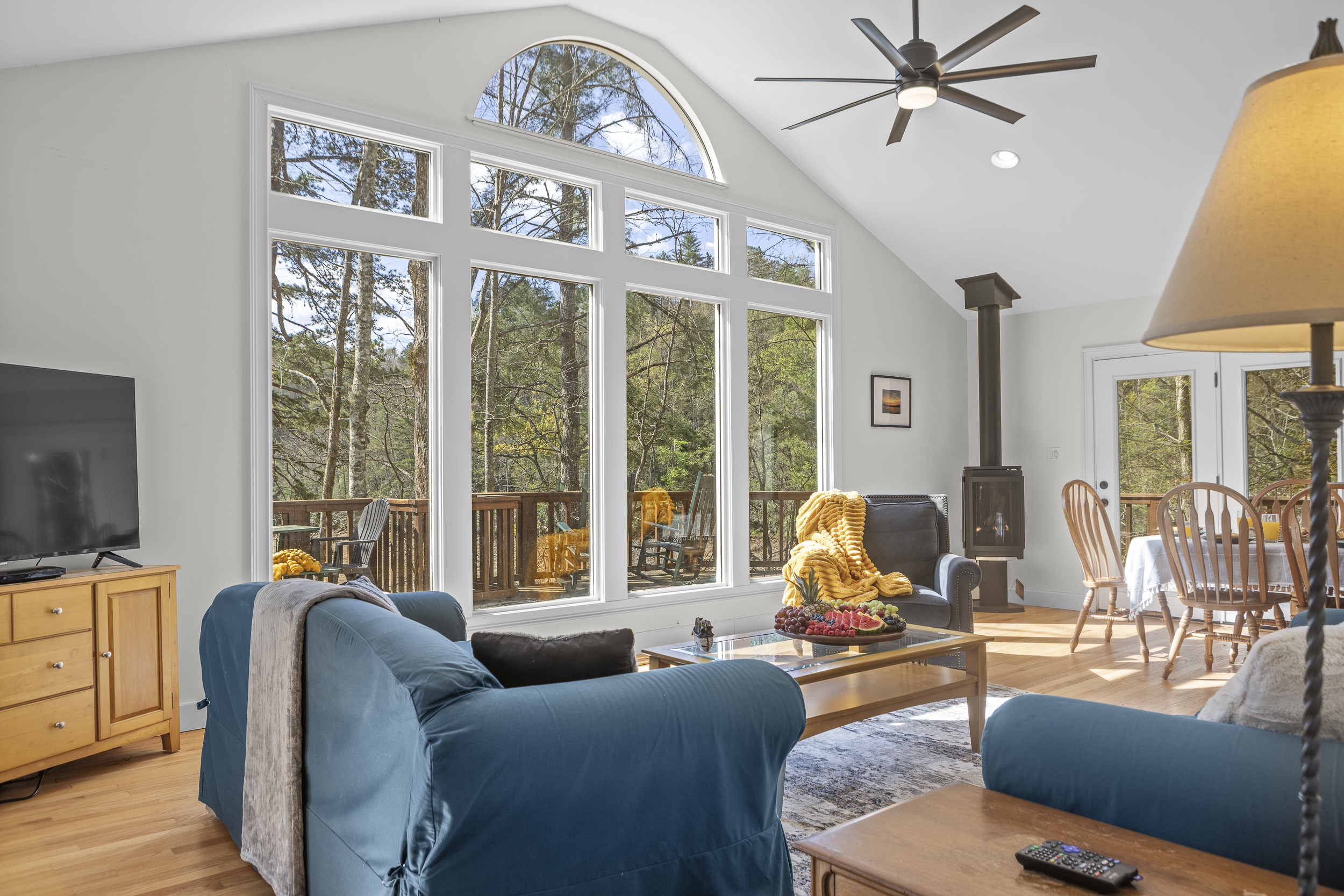Living Room: Enjoy stunning forest views and bright natural light in this stylish gathering space!