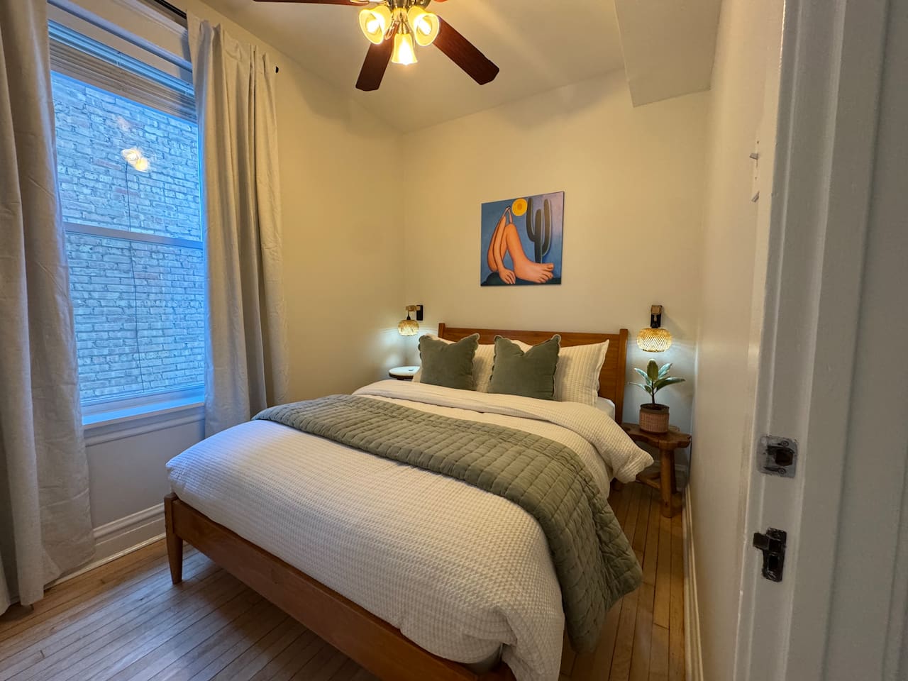Comfortable bedroom with soft linens and natural light.
